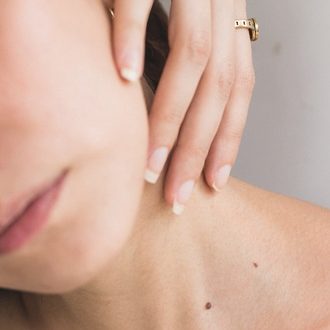 youthful radiant skin spa and facial service woman exposing neck and collarbone area
